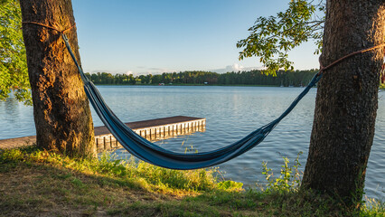 A pier over the Masurian lake and a hammock