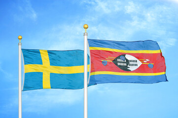 Sweden and Eswatini Swaziland two flags on flagpoles and blue sky