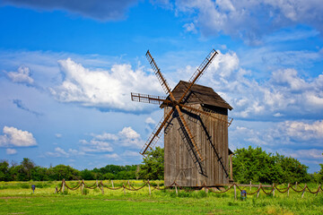 Fototapeta na wymiar old beautiful windmill sunny clear day on the field