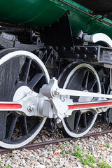 large white iron wheels of an old locomotive close-up vertical photo