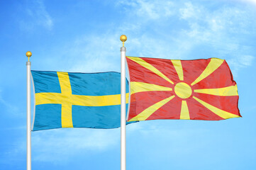 Sweden and North Macedonia two flags on flagpoles and blue sky