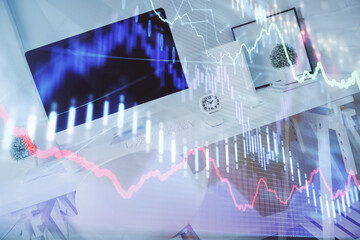 Double exposure of financial graph drawing and office interior background. Concept of stock market.