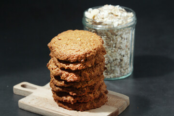 Homemade oatmeal cookie at dark background