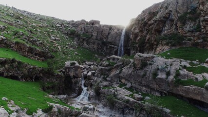 Aerial view of waterfall and mountain.