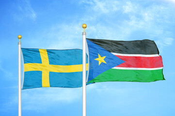 Sweden and South Sudan two flags on flagpoles and blue sky