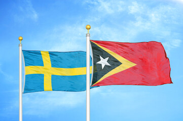 Sweden and Timor-Leste East Timor two flags on flagpoles and blue sky