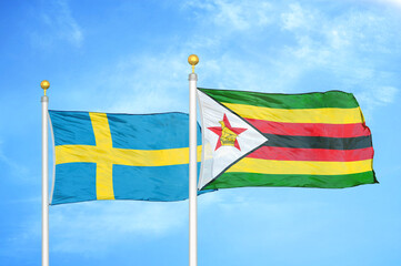 Sweden and Zimbabwe two flags on flagpoles and blue sky
