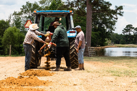 Family installing new fence on farm