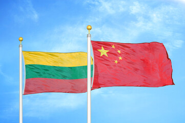Lithuania and China two flags on flagpoles and blue sky