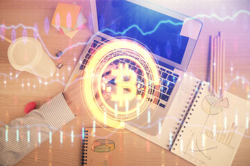 Obraz premium Double exposure of man's hands typing over computer keyboard and crypto currency theme hologram drawing. Top view. Blockchain concept.