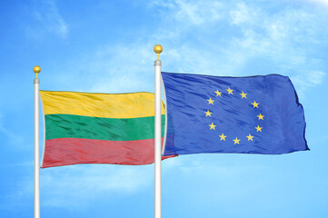 Lithuania and European Union two flags on flagpoles and blue sky