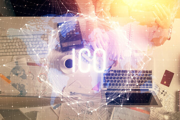 Double exposure of man and woman working together and crypto theme hologram drawing. Computer...