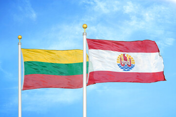 Lithuania and French Polynesia two flags on flagpoles and blue sky