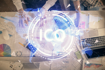 Double exposure of man and woman working together and crypto theme hologram drawing. Computer background. Blockchain concept. Top View.