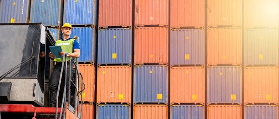 Portrait of confident inspector standing in front of containers in port, Dock worker with clipboard checking cargo freight shipping, Concept of transportation, logistics business. 21:9 wide photo - obrazy, fototapety, plakaty