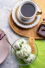 porcelain cup of coffee with pistachio ice cream  served  at table. life style concept