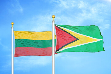 Lithuania and Guyana two flags on flagpoles and blue sky