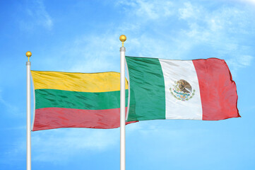 Lithuania and Mexico two flags on flagpoles and blue sky