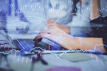 Multi exposure of woman hands typing on computer and financial graph hologram drawing. Stock market analysis concept.