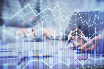 Multi exposure of woman hands typing on computer and financial chart hologram drawing. Stock market analysis concept.