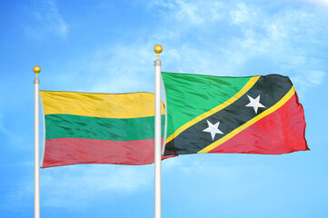Lithuania and Saint Kitts and Nevis two flags on flagpoles and blue sky