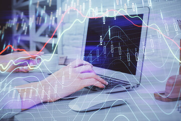 Multi exposure of woman hands typing on computer and forex chart hologram drawing. Stock market analysis concept.