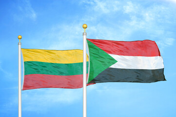 Lithuania and Sudan two flags on flagpoles and blue sky