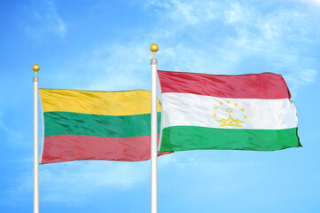 Lithuania and Tajikistan two flags on flagpoles and blue sky