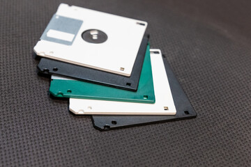 floppy disk white and black lies in a stack on a dark background engineering design