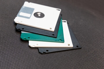 Obraz premium floppy disk white and black lies in a stack on a dark background engineering design
