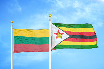 Lithuania and Zimbabwe two flags on flagpoles and blue sky