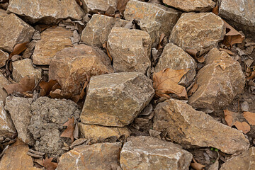stone beige, brown pattern of many cobblestones weathered and solid, the background of the quarry