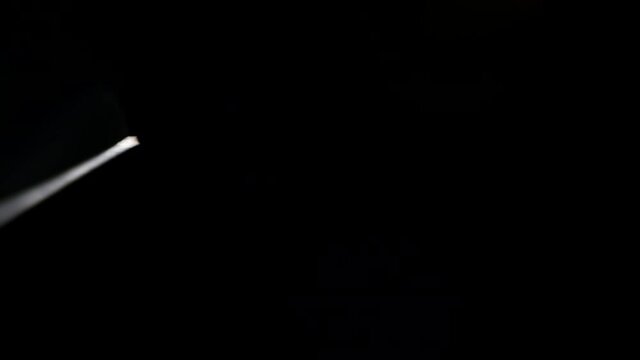 Extreme macro view of black steel blade rotation. EDC knife, hand tool, instrument concept. Isolated object on dark background.