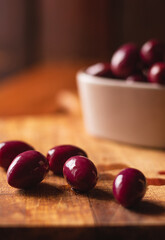 Purple olives on a chopping board