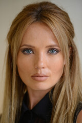 Naklejka premium Young beautiful businesswoman with blond hair indoors