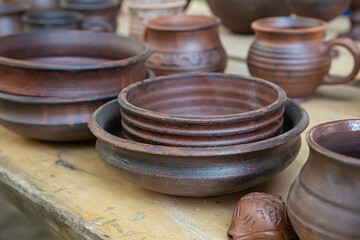 crockery set of home utensils, a bowl and a plate standing on the table close-up