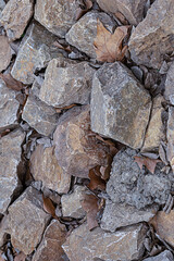 stone dark brown pattern, pile of cobblestones, mountainside with dry fallen leaves