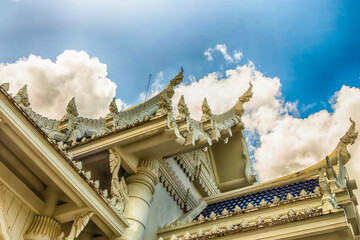 Fototapeta na wymiar traditional asian white marble temple with stone dragons on a carved roof