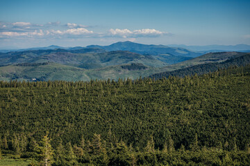 A sign with a mountain in the background