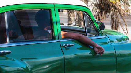 Obraz premium Havana, Cuba. The colorful and vibrant vibe of the famous capital streets. Havana knows also as Habana in Spanish is one of the oldest and largest cities in the Caribbean sea. 