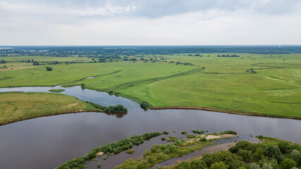 Aerial view of river Dnepr, Belarus. River and meadow from above. Landscape of fields and river. Space for text.