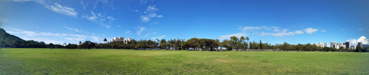 Kapiolani Park at during day with Diamond Head and clouds
