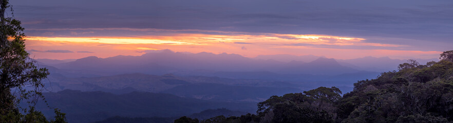 Fototapeta na wymiar Panoramic Rainforest Sunset with Misty Valley View