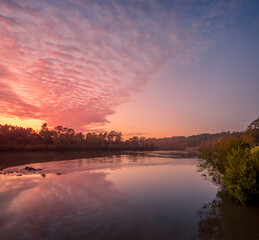 Fototapeta na wymiar Beautiful Riverside Sunrise with Reflections