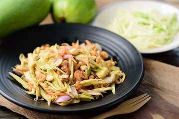 Thai food (Yum Mamuang), Spicy green mango salad on wooden background