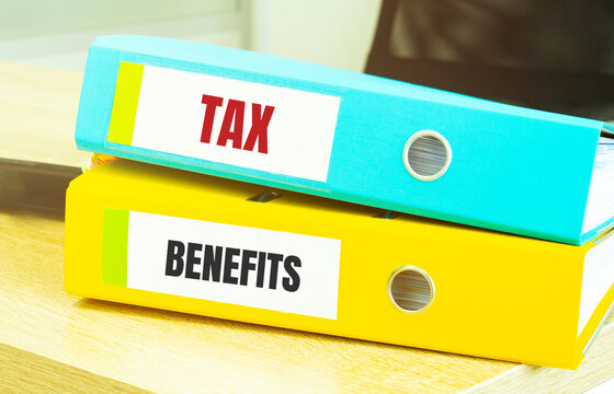 Two Office Folders With Text TAX Benefits