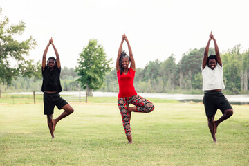 Mother and sons doing yoga in park