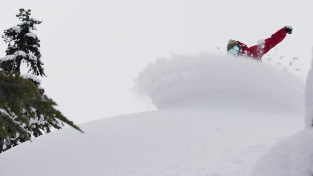 Snowboarder in Fresh powder snow Slashing snow in Whistler BC Slow motion. 