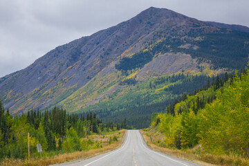 Roadtrip view in norther BC with Highway and Mountain in the background 