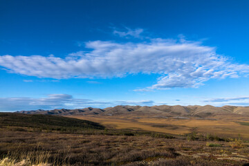 Arctic Tundra in fall with mountains and clouds in the Yukon